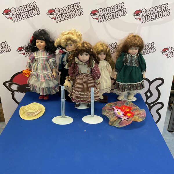 Vintage porcelain collector dolls with stands and accessories.