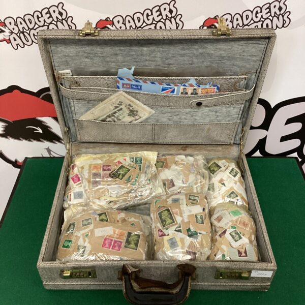 Vintage suitcase filled with a diverse postage stamp collection.