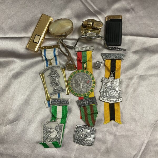 Mixed lot of vintage French medals and a Zippo lighter.