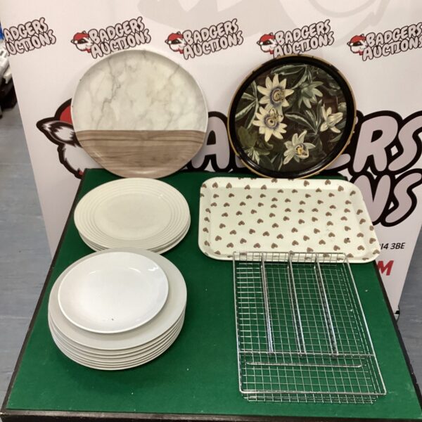 White dinner plates and serving trays on display.