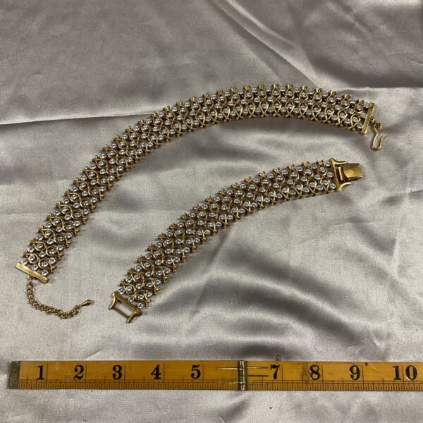 Sparkling crystal gold tone necklace and bracelet set.
