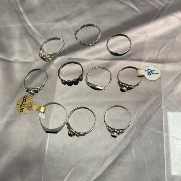 Assorted small silver rings presented as a jewellery lot.