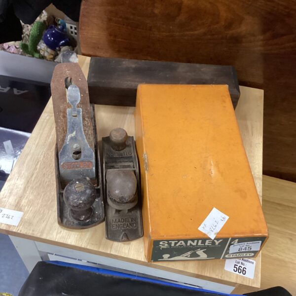 Vintage Stanley wood planes with sharpening block for woodworking.