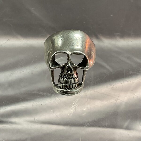 Close-up of detailed silver skull ring, gothic jewellery.