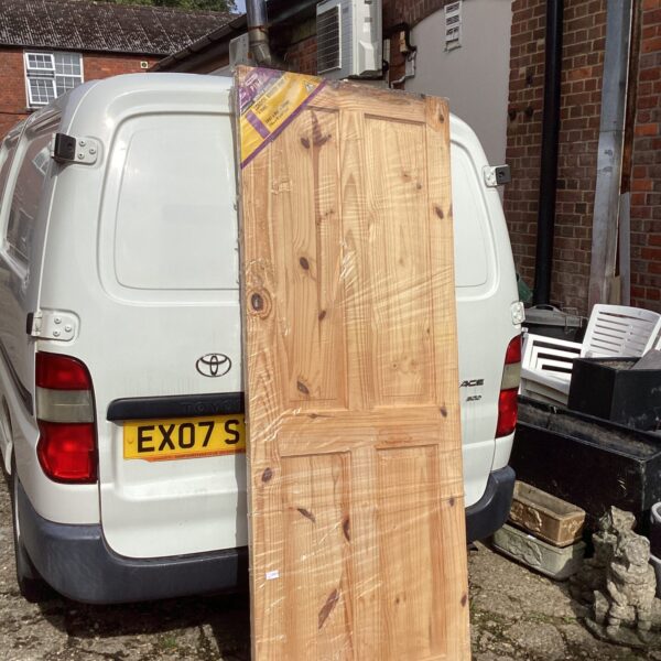 Vintage pine door measuring 78x30 inches, ideal for renovation.