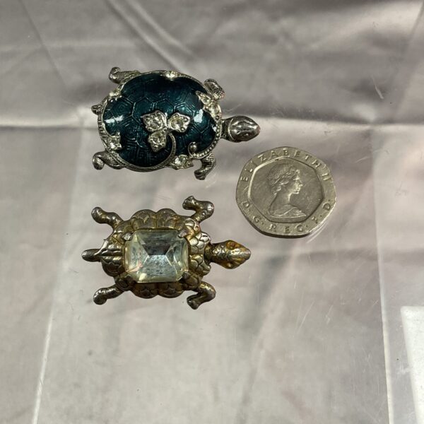 Pair of vintage tortoise brooches in silver tone and green enamel.