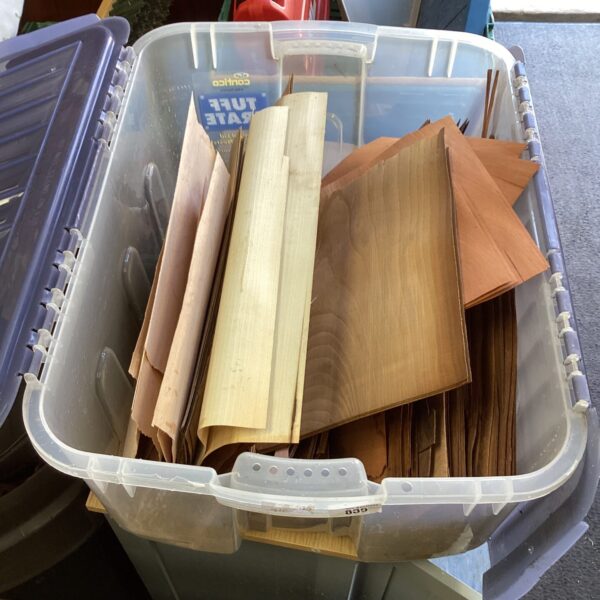 Mixed lot of colourful wood veneer sheets for crafting projects.