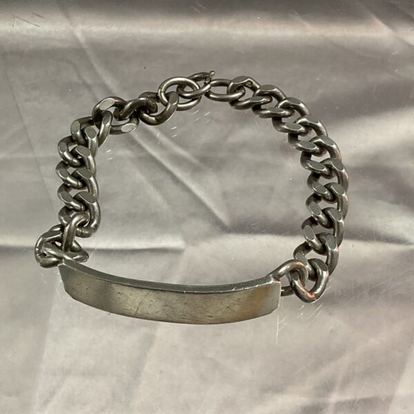 Vintage silver identity bracelet with engraved plate.