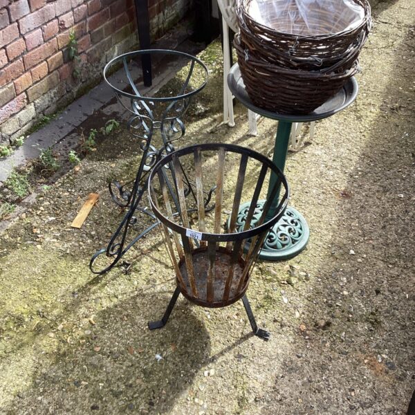 Vintage wrought iron garden stand with hanging baskets.