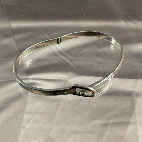 Close-up of a vintage 925 silver hinged bracelet.
