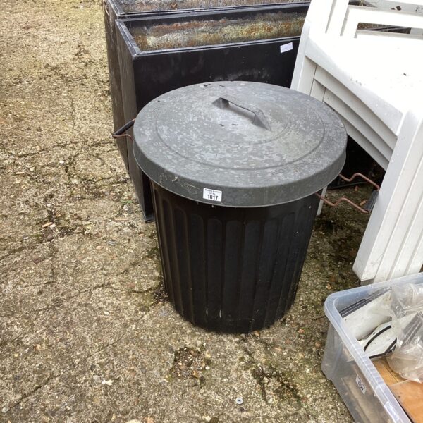 Black plastic garden waste bin for outdoor use.