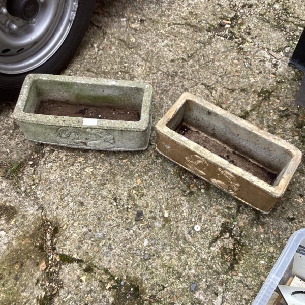 Small stone effect garden planters for outdoor display.