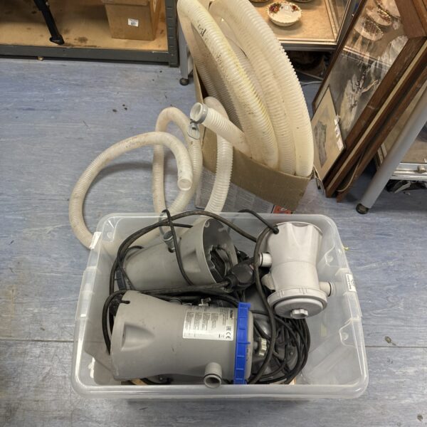 Selection of pond pumps and tubing for garden water features.