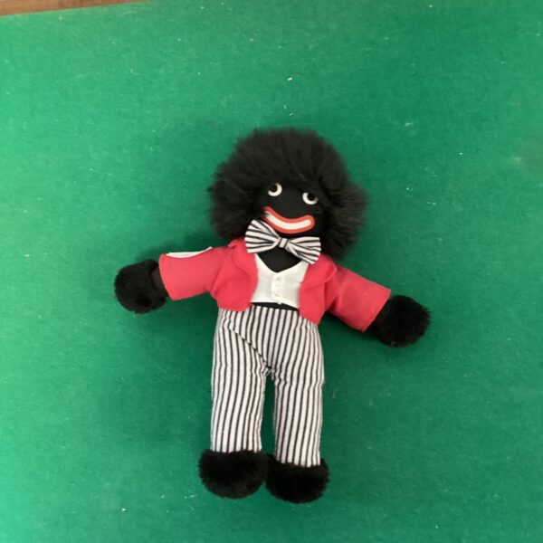 Vintage Golly soft toy with red jacket and striped trousers.