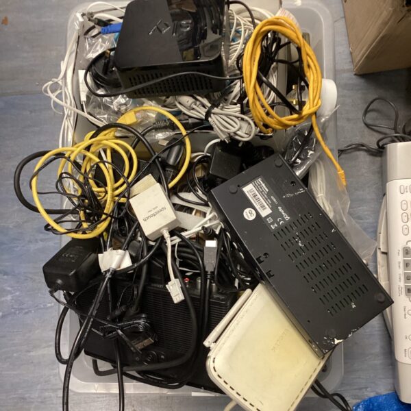 Mixed lot of routers and cables for internet connectivity.