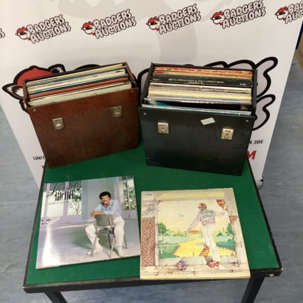 Vintage suitcase filled with a vinyl record collection.