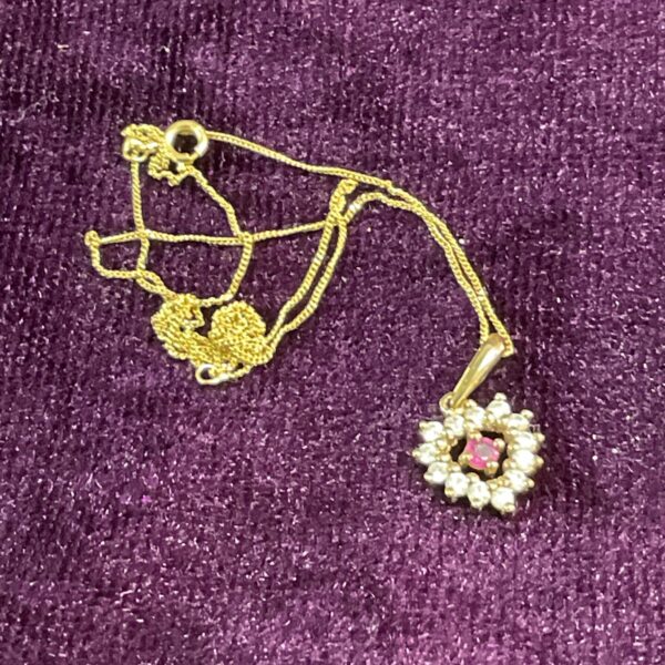 Delicate 9ct gold necklace with a red and white stone heart pendant.