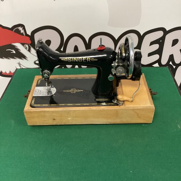 Vintage Singer sewing machine with ornate detailing.