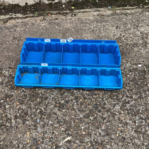 Pair of plastic tool organiser trays for workshop storage.