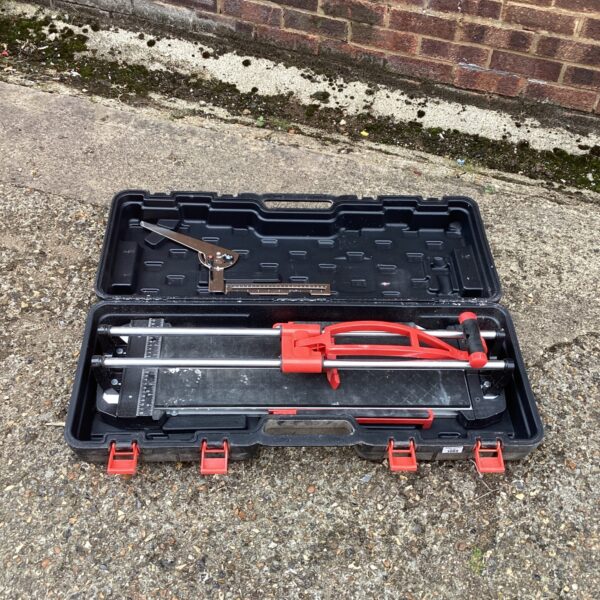 Manual tile cutter in a black carrying case, flooring tool.