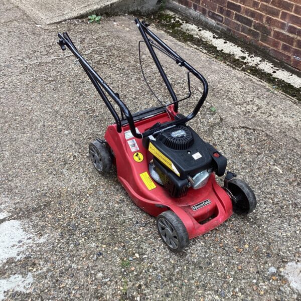 Red Mountfield petrol mower for garden maintenance and repair.