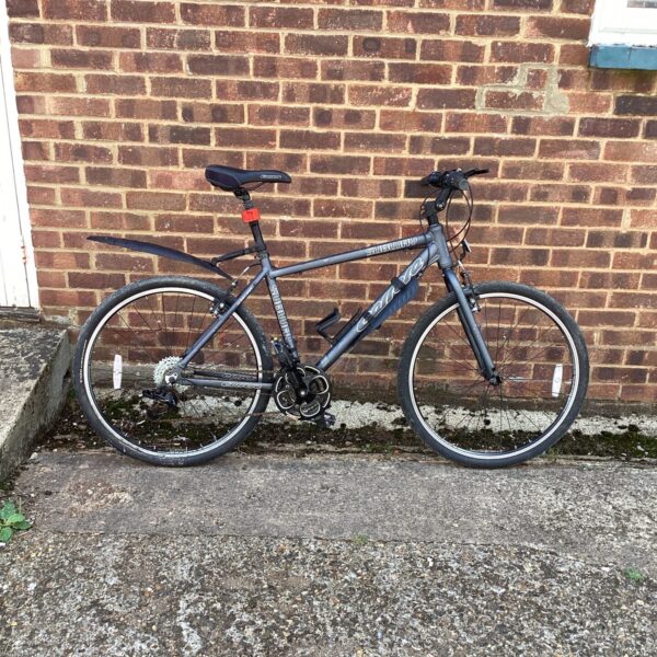 Side view of a grey Carrera Subway hybrid bike.