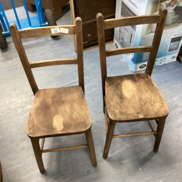 Pair of vintage wooden childs chairs with rustic charm.