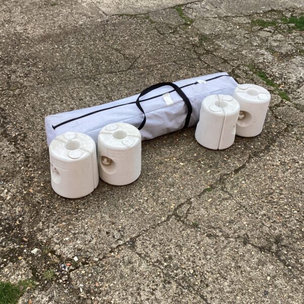 Set of four plastic garden gazebo weights for stability.