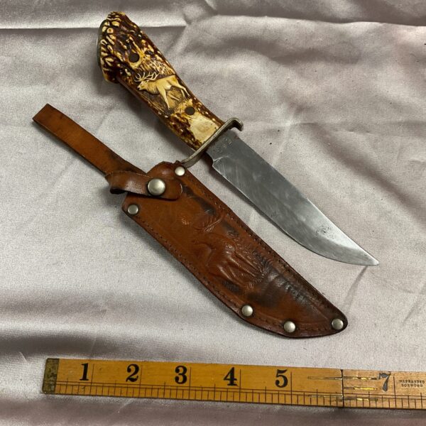 Vintage Solingen knife with stag horn handle and leather sheath.