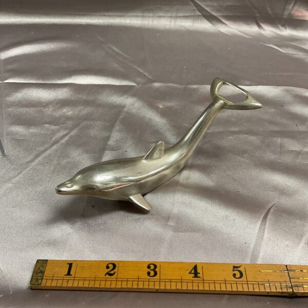 Vintage 1970s dolphin bottle opener for retro barware collectors.