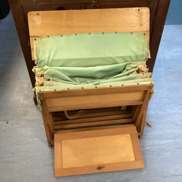 Unfolded vintage campaign bed showing canvas sleeping surface.