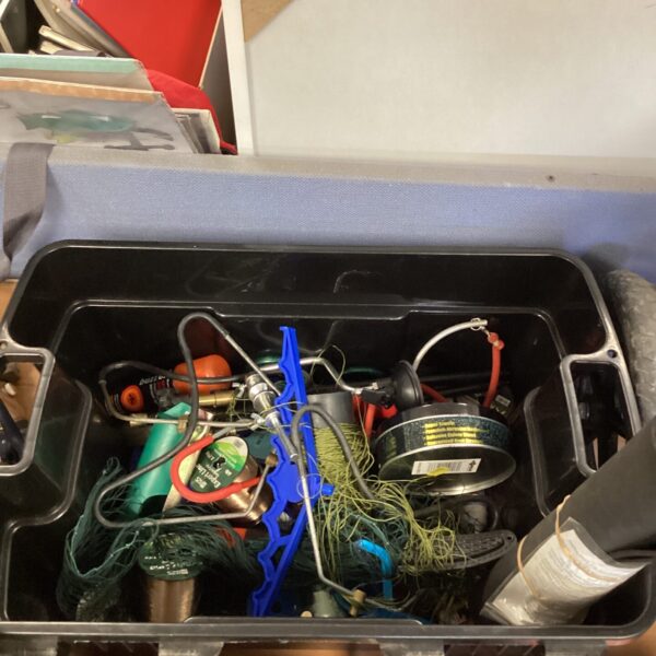Mixed fishing tackle box with line and rod rests.