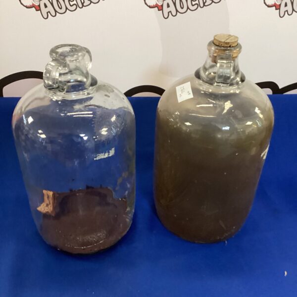 Pair of vintage glass demijohns for wine making and storage.