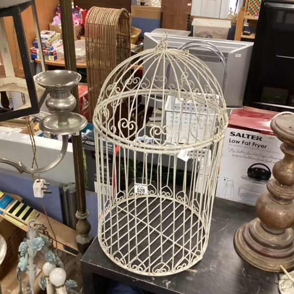 White vintage metal bird cage for decorative display.