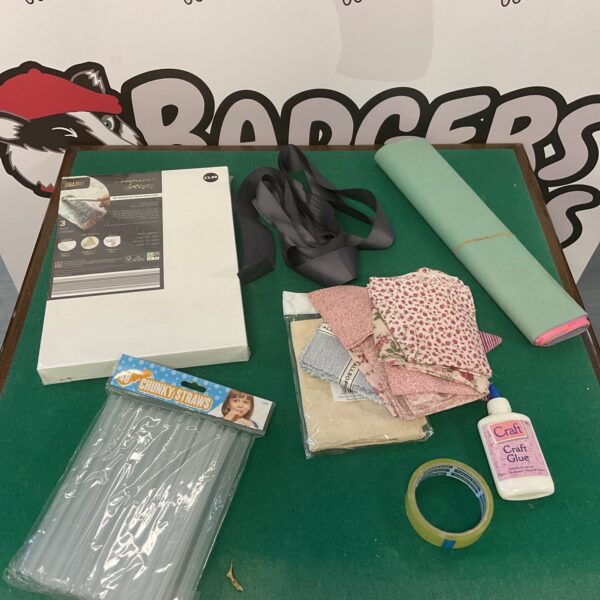Mixed craft lot with fabric, ribbon, and patterned paper.