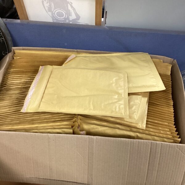 Stack of used Malier padded envelopes for shipping and protection.