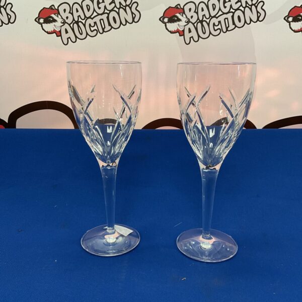 Pair of Waterford crystal goblets by John Rocha on blue background.