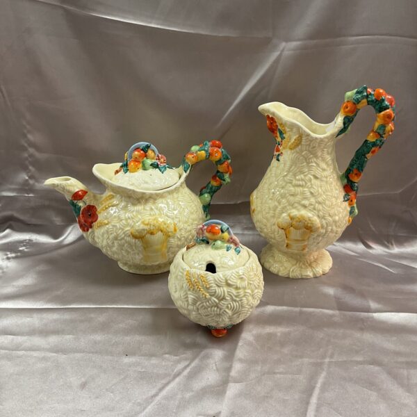 Vintage Clarice Cliff Celtic Harvest teapot, jug, and jam pot collection.
