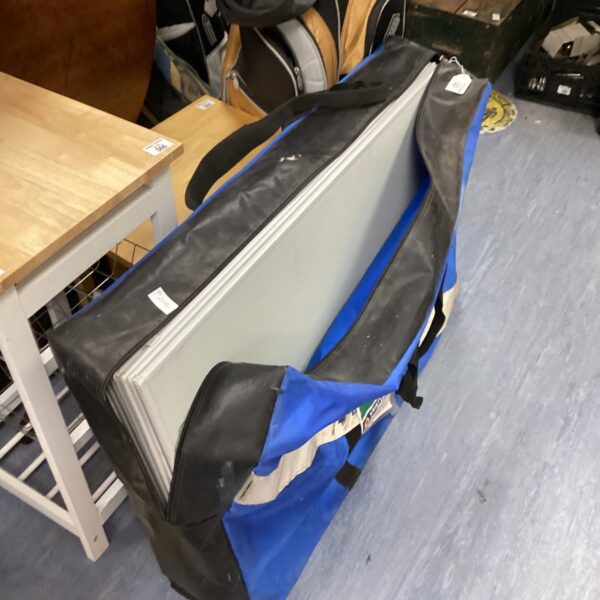Folding notice boards stored in a blue carrying bag.