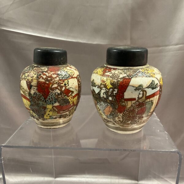 Pair of antique Chinese ginger jars with detailed hand-painted scenes.