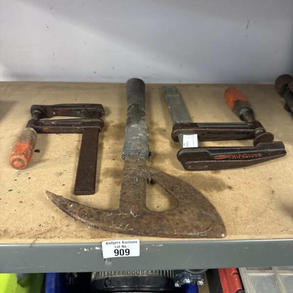 Vintage metal clamps and WWII escape axe for collectors.
