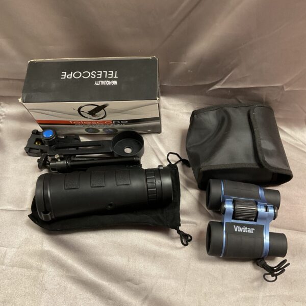 Vintage pocket telescope with tripod and Vivitar binoculars on display.