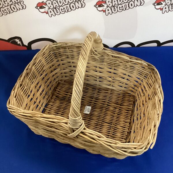 Vintage wicker basket with handle, ideal for farmhouse decor.