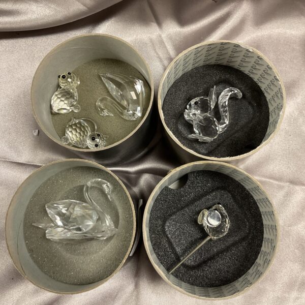 Four tubs filled with sparkling Swarovski crystal animals.