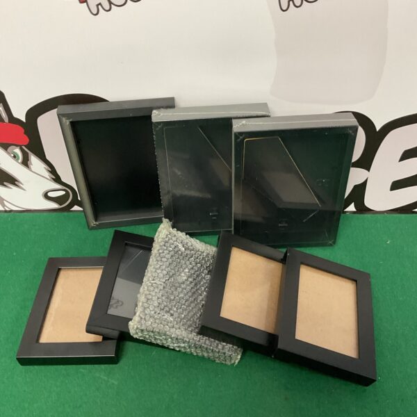 Lot of eight black photo frames for display.