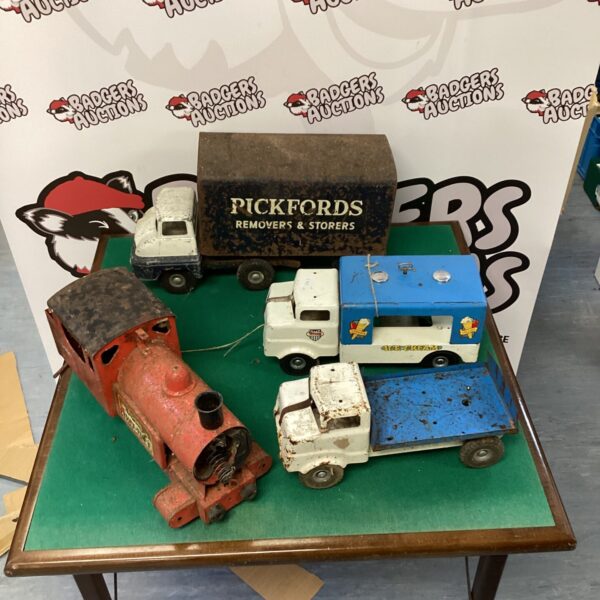 Vintage metal toy trucks and steam train lot for collectors.
