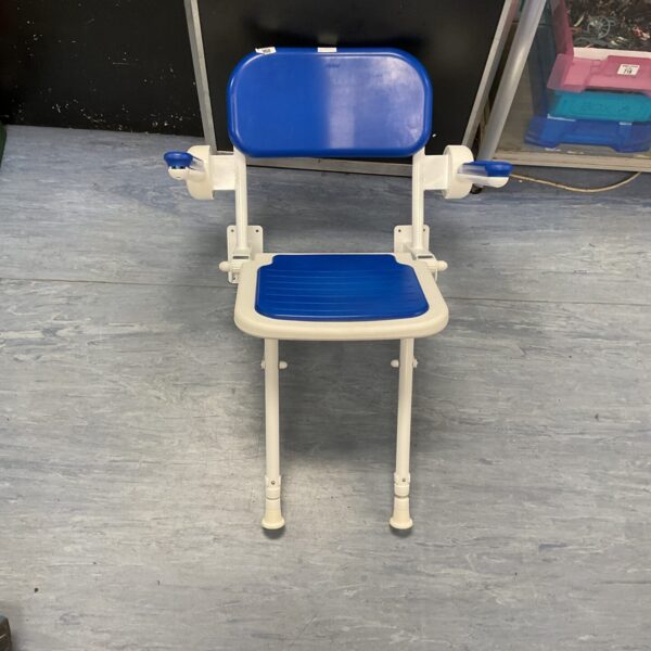 Blue AKW folding shower seat, wall mounted for bathroom accessibility.