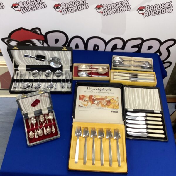 Vintage silverplate cutlery set by Viners, displayed on a table.