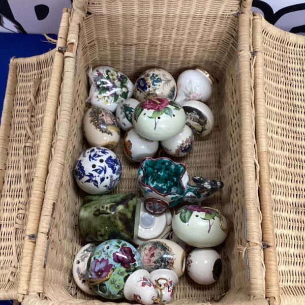Vintage ceramic pomanders displayed in a wicker basket.