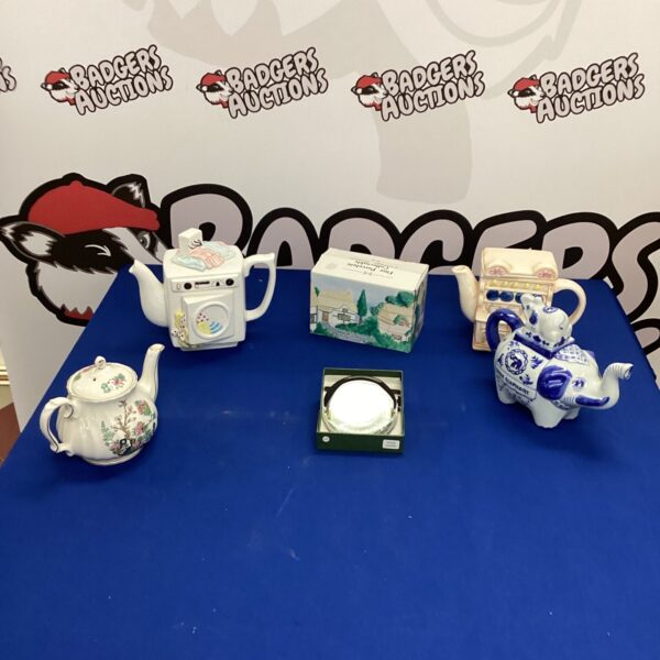 Selection of colourful novelty ceramic teapots for collectors.